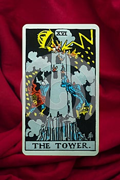 THE FOOL major tarot card of Rider Waite deck on red fabric background