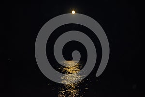 The fool moon over the sea and the moonpath