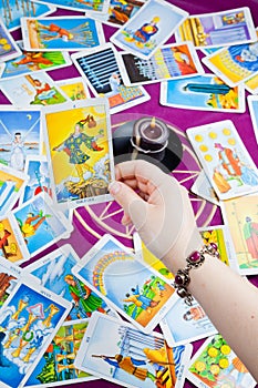 The Fool. Tarot card held in hand.