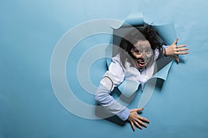 Foolish humorous scientist with comic expression on blue background