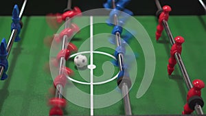 Foosball known as table soccer, blue and red players in football kicker game