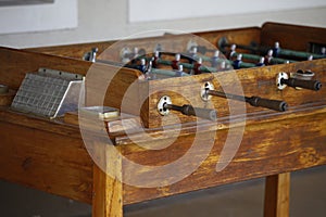 Foosball. Soccer hall game. Traditional game. Soccer game. Table with soccer players. Old wooden foosball. Football players. Dolls