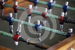 Foosball. Soccer hall game. Traditional game. Soccer game. Table with soccer players. Old wooden foosball. Football players. Dolls