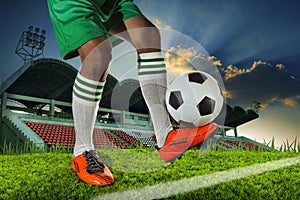 Foot ball player holding foot ball on leg ankle on soccer sport