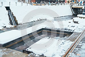 Foot bath hot spring in Ginzan Onsen with snow fall in winter season is most famous Japanese Hot Spring in Yamagata, Japan