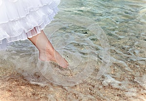 The foot of the bride touches water in the sea