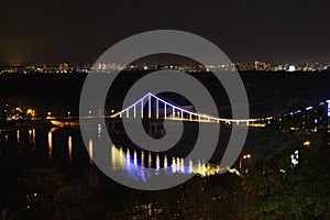 Foot bridge illuminated as a central part of night Kiev