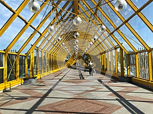 Foot bridge inside. sunny day. white-orange bridge