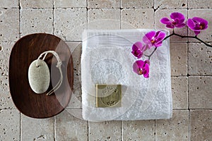 Foot care concept with pumice stone, Alep soap and white towel, flat lay