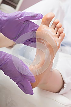 Foot care massage with cream. Pedicure SPA procedure. photo