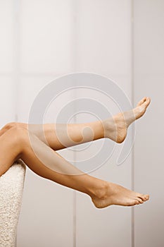 Foot care. Skin care, cosmetology and pedicure. Depilation of hair on the feet. Beautiful well-groomed female legs
