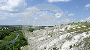 At the foot of the chalk mountains the river flows