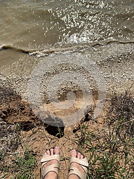 Foot at the edge of a cliff