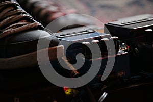 Foot on guitar guitar pedalboard