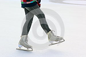 Foot ice-skating girls on the ice rink