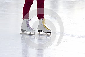 Foot ice-skating girls on the ice rink