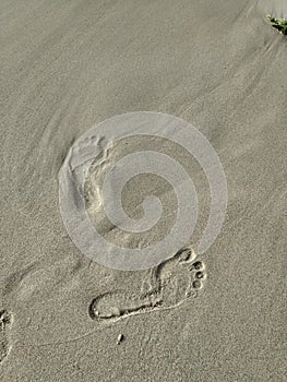 The foot impression on the beach sand