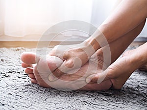 Foot injury use hand massage on feet to relax muscle from heel pain, ankles and bones from inflammation of tendons