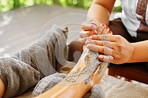 Foot Massage. Body Skin Care. Masseur Massaging Feet. Spa Treatment
