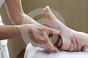Foot massage with bronze bowl