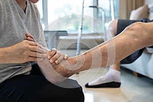 Foot massage physical therapy to relieve muscle spasms,massage the tired muscles of senior woman,feet numb from diabetes,old