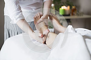 Foot massage treatment in asian spa salon