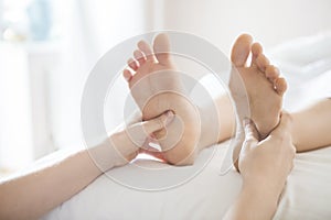 Foot massage treatment in asian spa salon