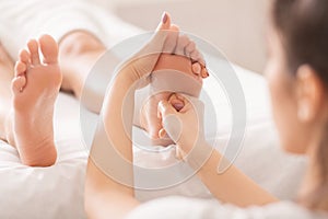 Foot massage. Woman relaxing at spa salon