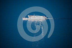 Foot passenger ferry reflective on lake surface photo