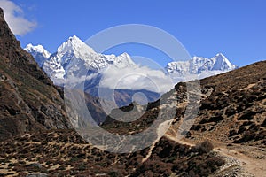 Foot path and Majestic mountains Thamserku and Kantega photo