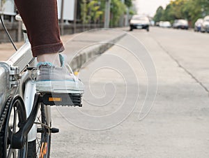 Foot on pedal of bicycle ready for departure