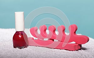 Foot pedicure red nail polish and toe separators