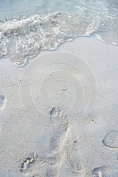 Foot print on sand at beach.Thailand