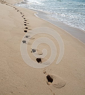 Foot prints on sandy paradise beach