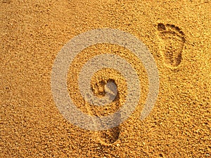 Foot prints on sea beach sand