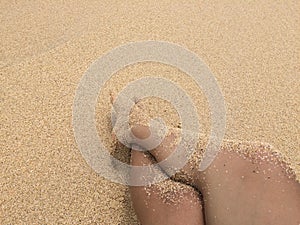 Foot and sand in the beach