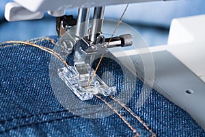 Foot Of Sewing Machine On Jeans Fabric.