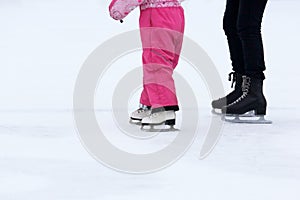 Foot skating girls and women on an ice rink