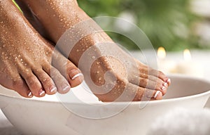 Foot spa on a tropical green leaves background