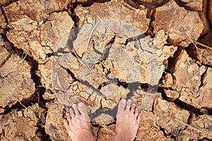 Foot stand on cracked dry land without water - color effect