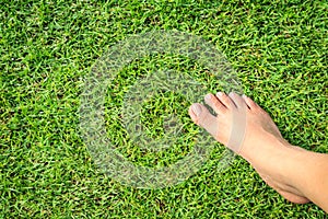 Foot step on green grass