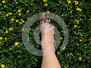 Foot stepping on green grass