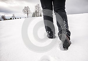 Foot steps walking at snow in winter