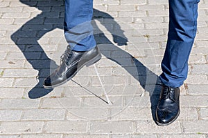 Foot stuck into chewing gum on street. Concept of stickiness