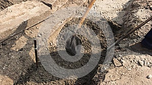 Foot of worker with shovel.