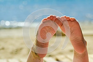 Foot of young sunburnt girl