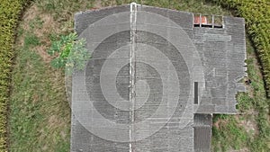 Footage of Aerial view of abandoned old wooden house in the middle of paddy field.