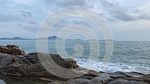 Footage b roll angry dangerous waves crashing on a rock. sea and ocean coastline. water splashing in strong windy day at seaside.