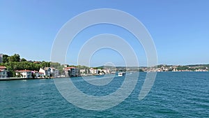 Footage of boats passing and Istinye / Yenikoy area of Istanbul by Bosphorus strait. Beautiful scene.