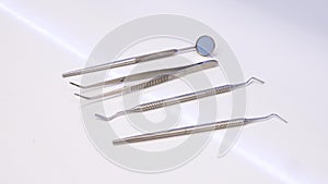 Footage of a dentists equipment lying on a table, the shot moves from right left